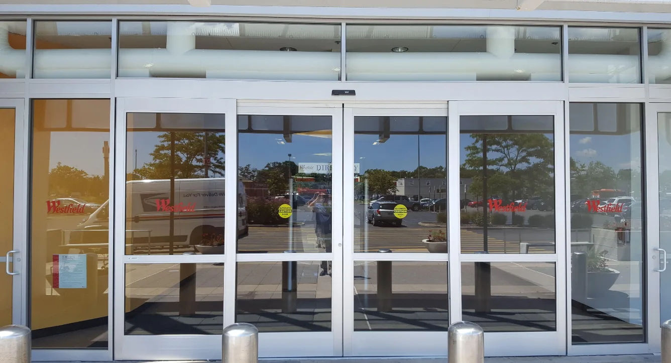Triton Locksmith repairing automatic sliding door operator at commercial building in South Florida
