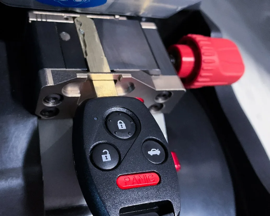 Cutting spare car key on mobile key machine at customer home in South Florida