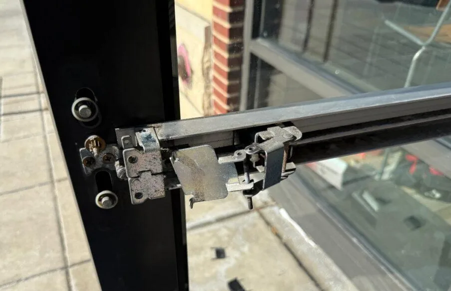 Triton Locksmith performing NFPA 80 fire door inspection checking gap clearance
