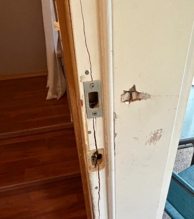 Steel reinforcement plate welded to commercial door frame strike area by Triton Locksmith