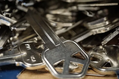 Cutting duplicate house keys on professional key machine for residential locks