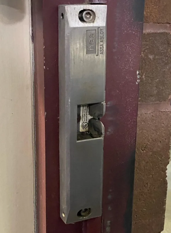 Triton Locksmith installing HES electric strike on commercial door frame in South Florida