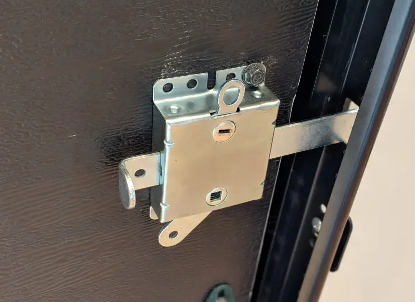 Garage door bolt lock installed on overhead door preventing manual lifting in South Florida home