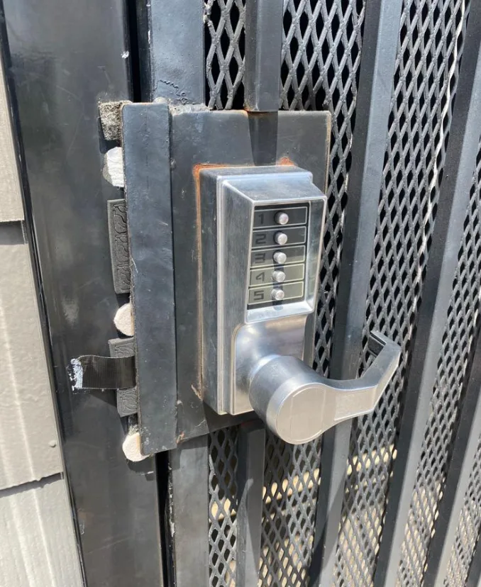 Keypad combination lock installed on residential gate for keyless entry in South Florida