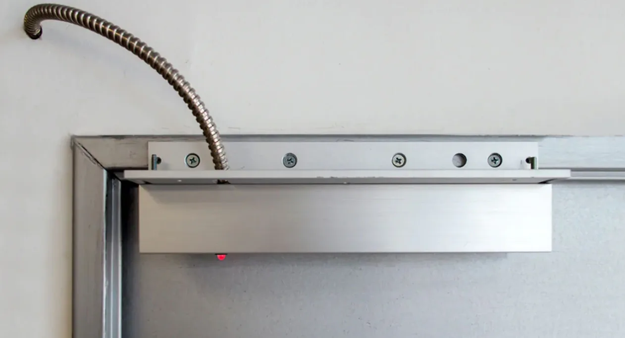 Triton Locksmith installing electromagnetic mag lock on commercial door in South Florida