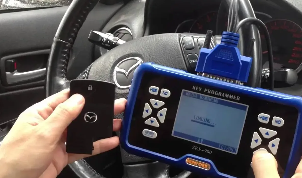 Locksmith programming transponder chip to car engine immobilizer through OBD-II diagnostic port