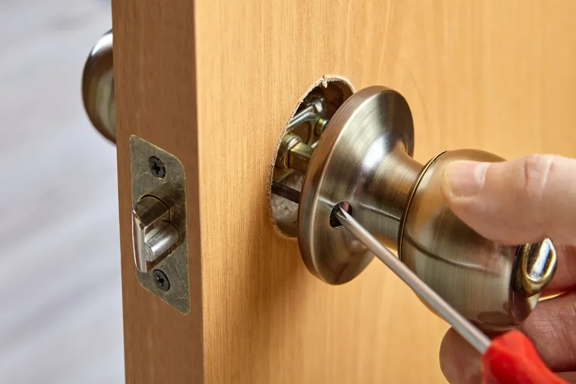 Locksmith repairing stuck residential door lock and deadbolt mechanism in South Florida home