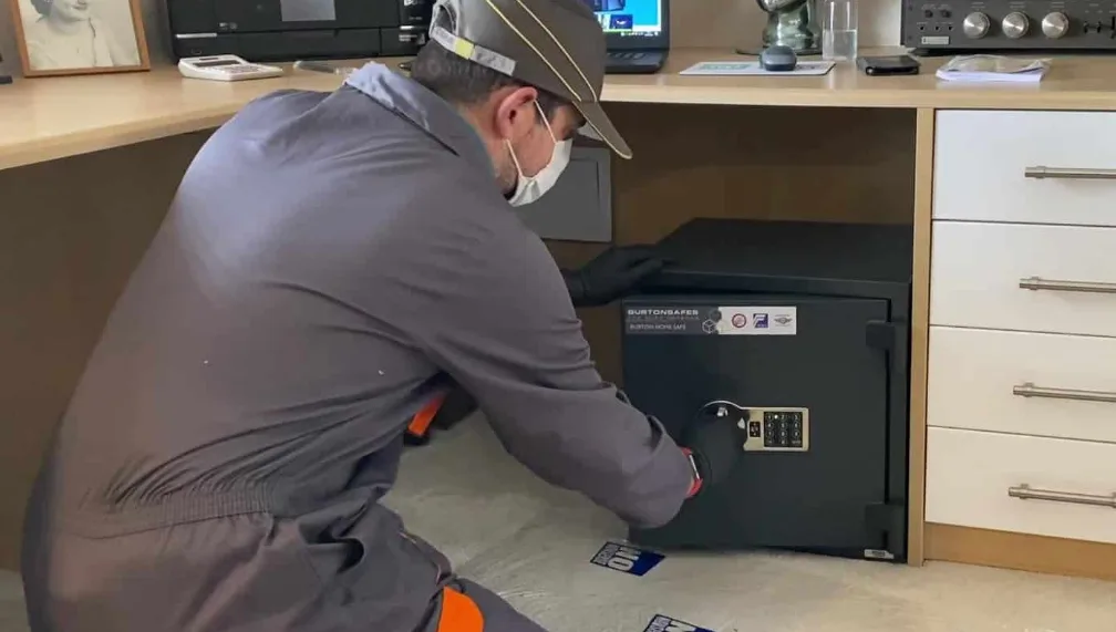 Triton Locksmith installing commercial floor safe with concrete anchoring at South Florida business