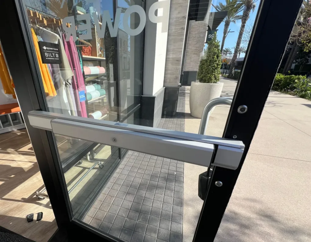 Triton Locksmith repairing narrow-stile mortise lock on retail storefront in South Florida
